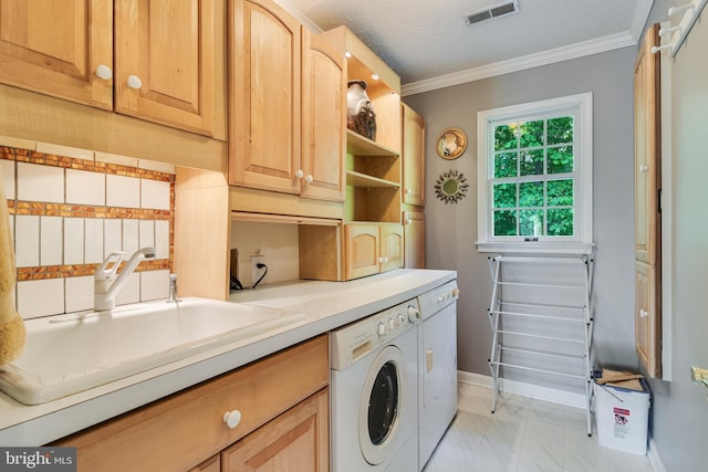 clothes washing area featuring visible vents, crown molding, a sink, marble finish floor, and washer and dryer