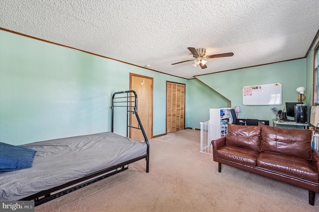 carpeted bedroom with ornamental molding, a textured ceiling, and baseboards