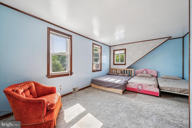 bedroom with crown molding, carpet floors, baseboards, and visible vents