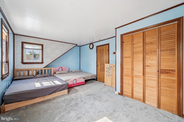 bedroom with carpet floors, a closet, and wallpapered walls