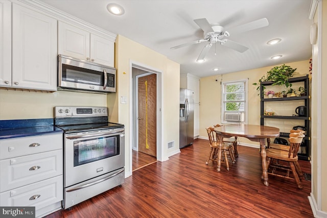 kitchen with stainless steel appliances, white cabinets, and dark wood finished floors
