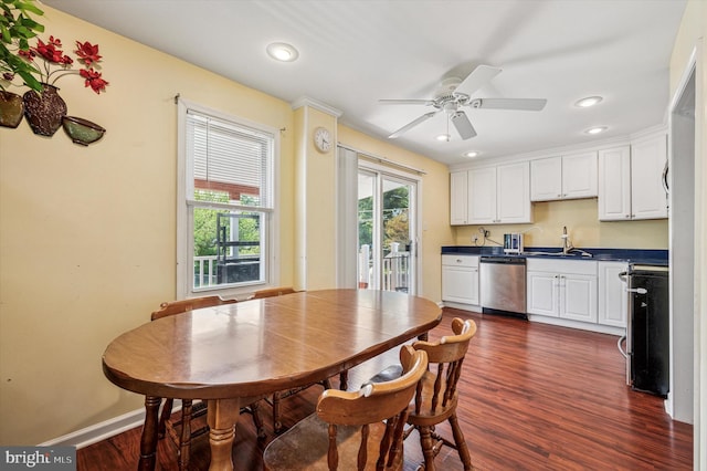 kitchen with a sink, range, dark countertops, dark wood finished floors, and dishwasher