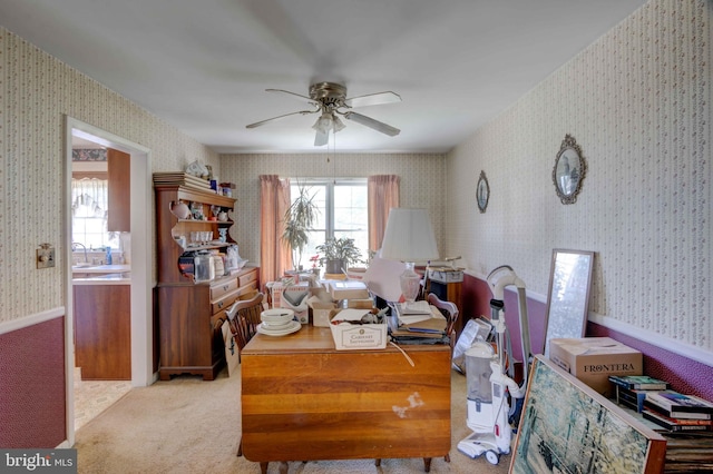 home office featuring carpet floors, a ceiling fan, and wallpapered walls