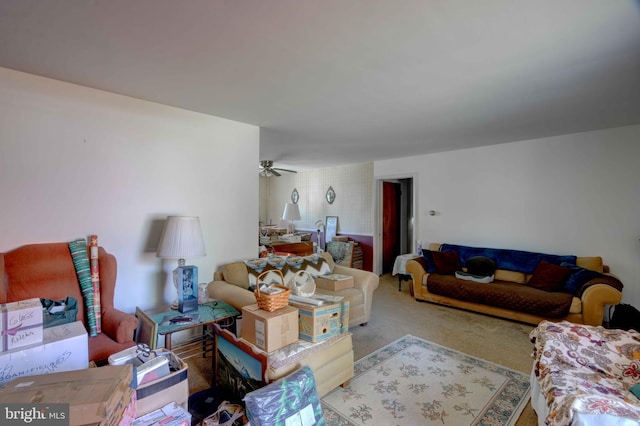 living room with a ceiling fan and carpet flooring