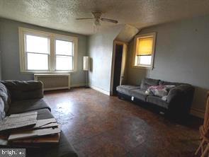 4815 E Roosevelt Blvd, Philadelphia, PA 19124 - living room with a textured ceiling and ceiling fan