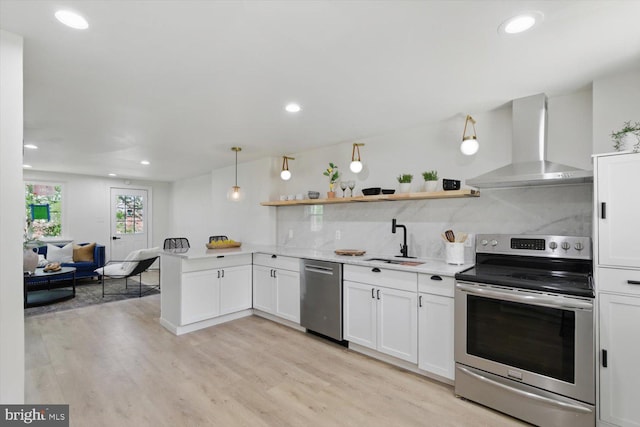 408 Fairview Ave, Lancaster, PA 17603 - kitchen featuring recessed lighting, light countertops, wall chimney exhaust hood, a sink, and appliances with stainless steel finishes