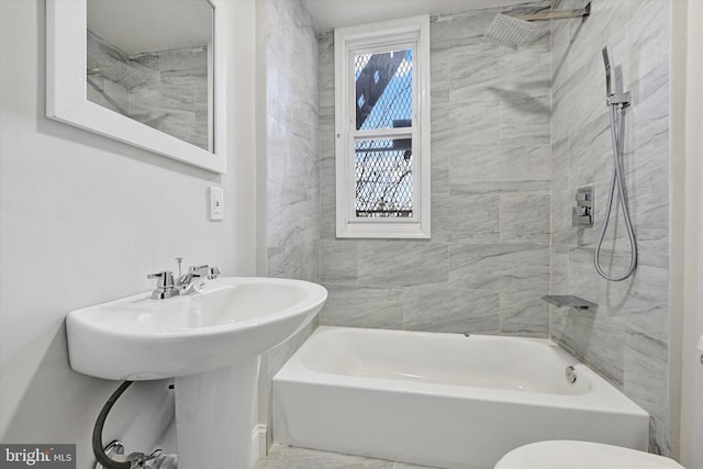 bathroom with a sink, toilet, and  shower combination