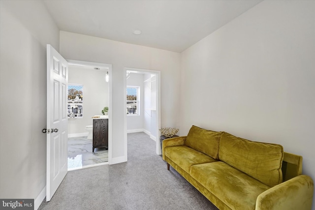 living area featuring carpet floors and baseboards