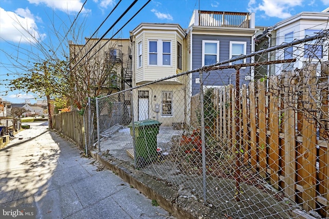 exterior space with a gate, fence private yard, and a balcony