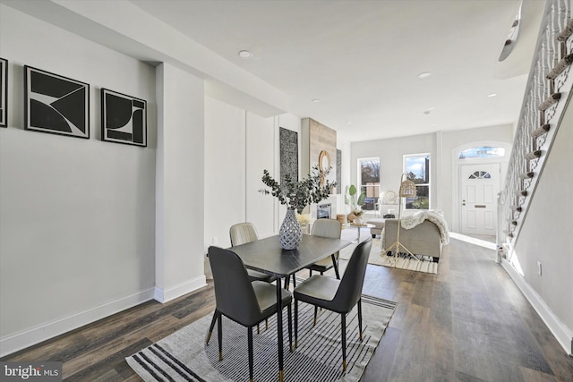 dining room with stairs, recessed lighting, baseboards, and dark wood-style floors