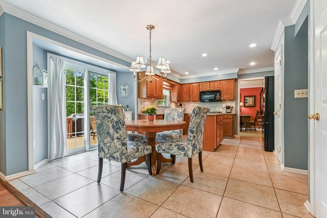 dining area featuring baseboards, ornamental molding, recessed lighting, and a notable chandelier