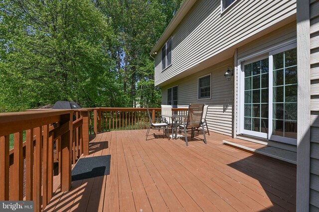 wooden terrace featuring outdoor dining area