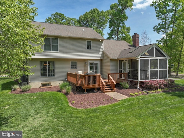 rear view of property with a shingled roof, a wooden deck, a sunroom, a chimney, and a yard
