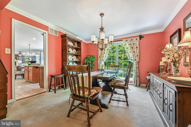 dining room featuring crown molding, a notable chandelier, and visible vents