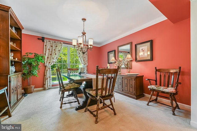 dining room featuring baseboards, ornamental molding, light colored carpet, and a chandelier
