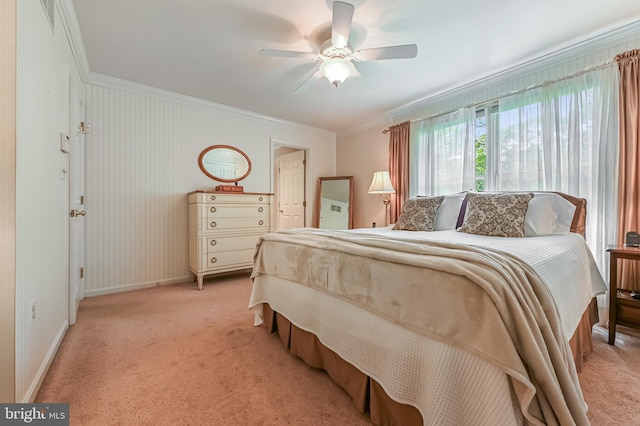bedroom featuring crown molding, a ceiling fan, baseboards, and light colored carpet