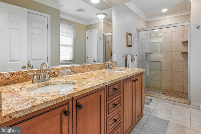 full bathroom with double vanity, a sink, a stall shower, and tile patterned floors