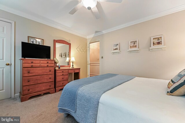 carpeted bedroom with crown molding and ceiling fan