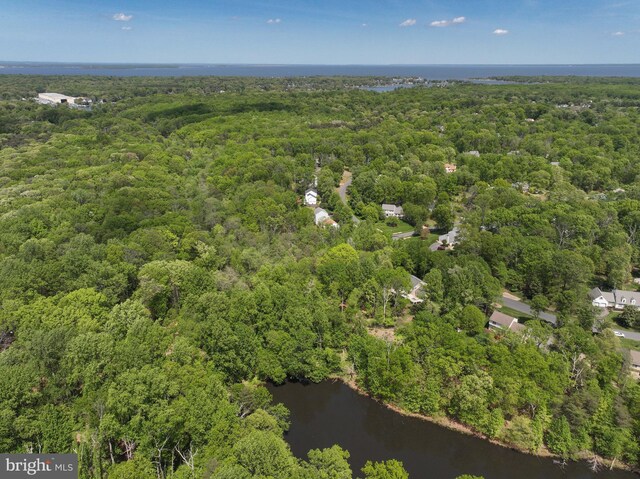 aerial view with a water view and a forest view