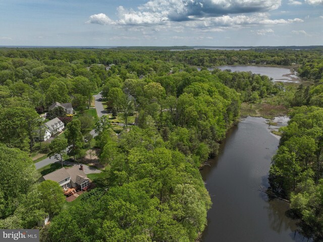 aerial view with a forest view and a water view