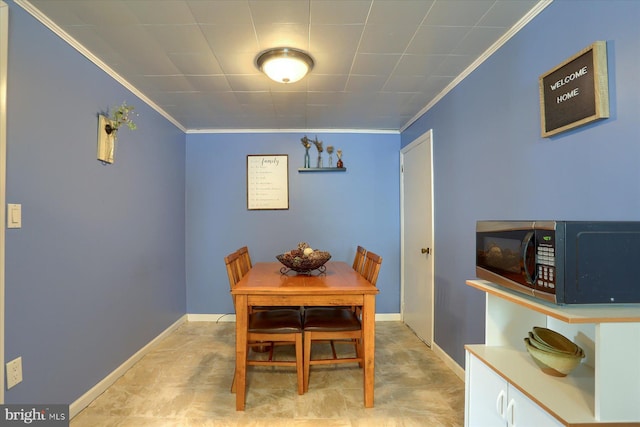 dining area with baseboards and ornamental molding