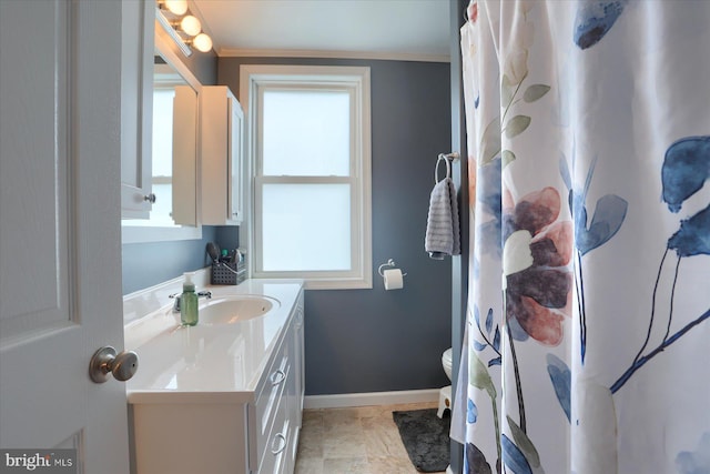 bathroom featuring crown molding, baseboards, curtained shower, and vanity