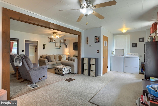 carpeted living area featuring a ceiling fan, independent washer and dryer, and visible vents