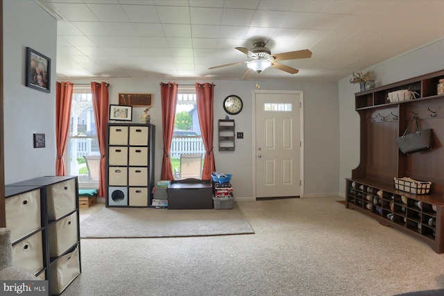interior space with carpet floors, baseboards, and a ceiling fan