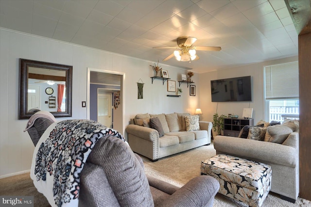 living room with crown molding, ceiling fan, and carpet flooring