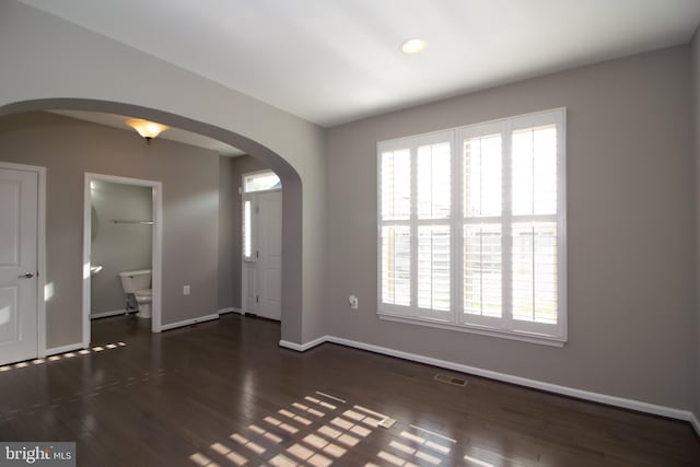 interior space with arched walkways, visible vents, and a wealth of natural light
