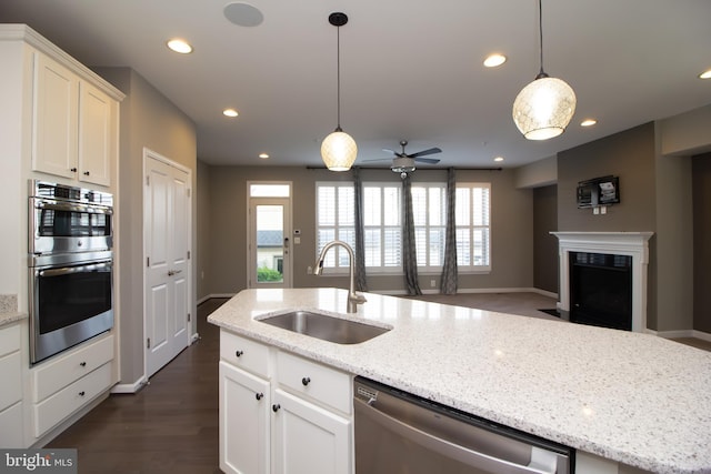 kitchen featuring white cabinets, stainless steel appliances, recessed lighting, and a sink