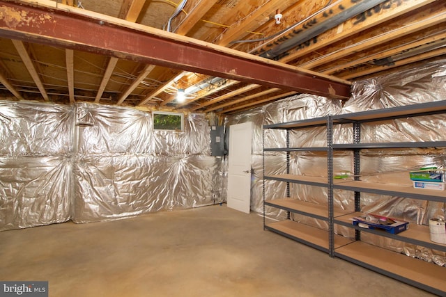 unfinished basement featuring electric panel