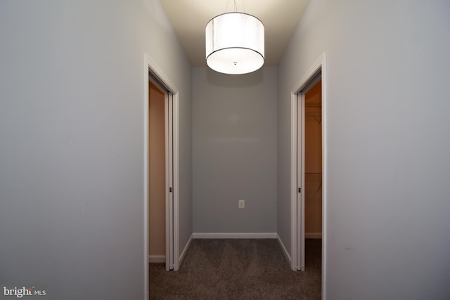 hall with baseboards and carpet