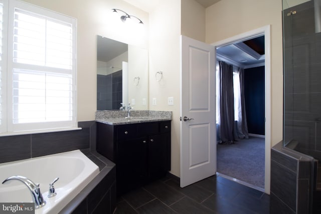 bathroom with vanity, a tile shower, and a garden tub