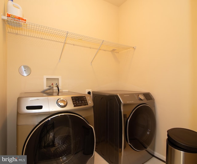 laundry room with separate washer and dryer, laundry area, and baseboards