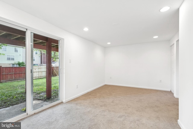 spare room featuring carpet, recessed lighting, and baseboards
