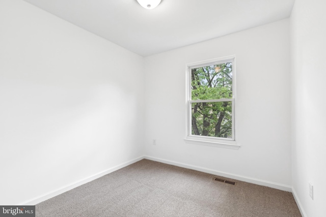 empty room with carpet floors and baseboards