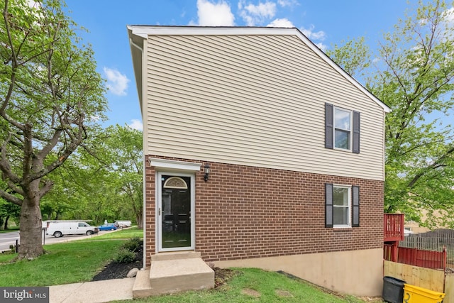 rear view of property with brick siding