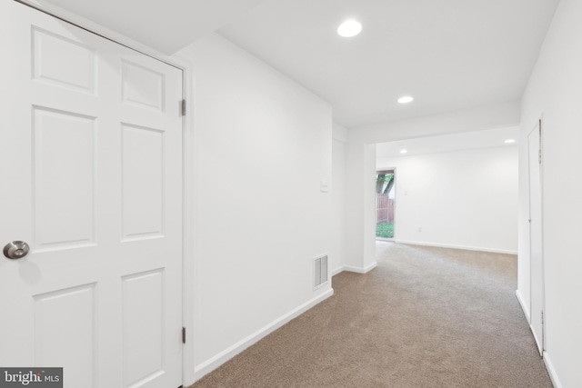 hallway featuring carpet flooring, recessed lighting, and baseboards