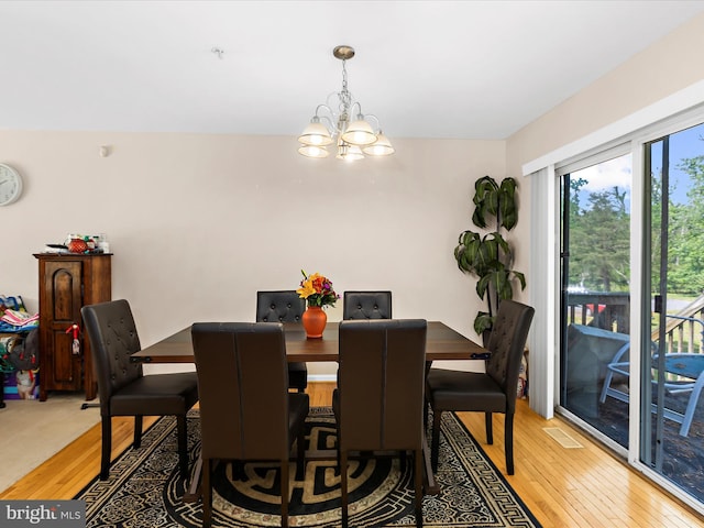 dining area featuring an inviting chandelier and light wood-style flooring