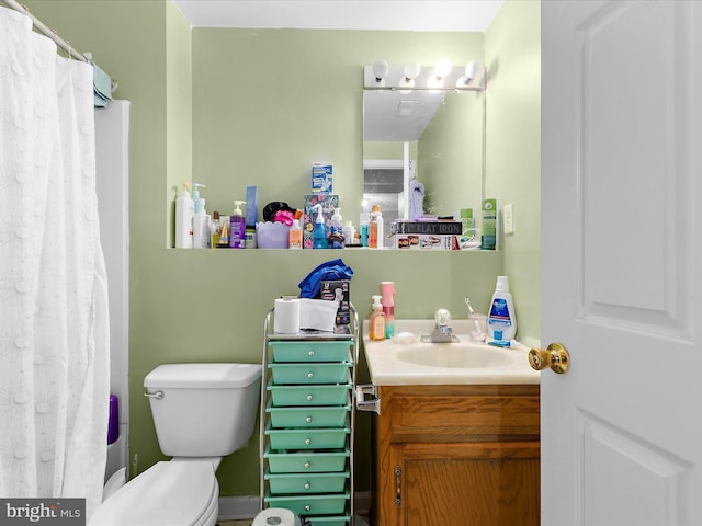 bathroom with vanity, a shower with shower curtain, and toilet