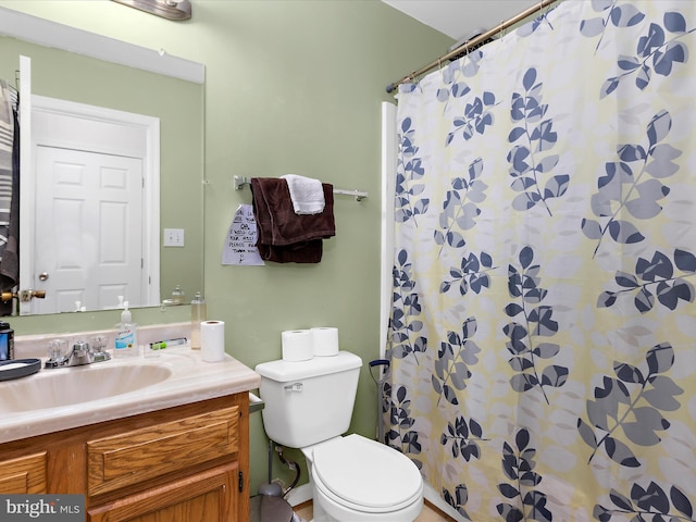 bathroom with toilet, a shower with shower curtain, and vanity