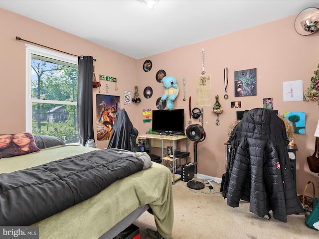 carpeted bedroom featuring baseboards