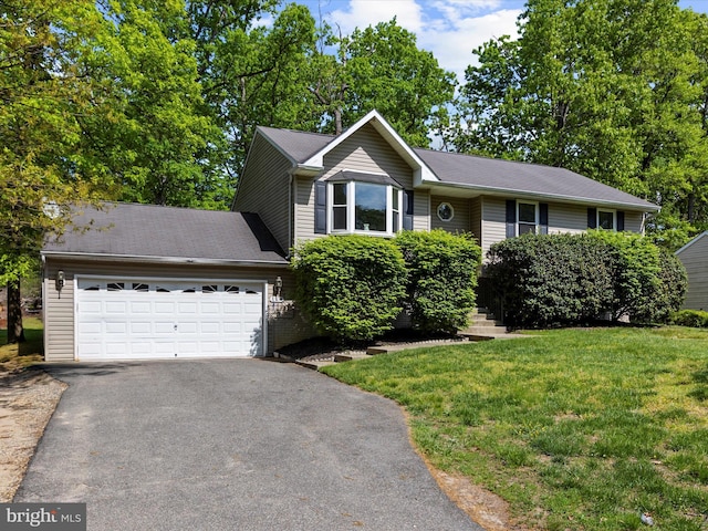 ranch-style house with a garage, a front lawn, and aphalt driveway