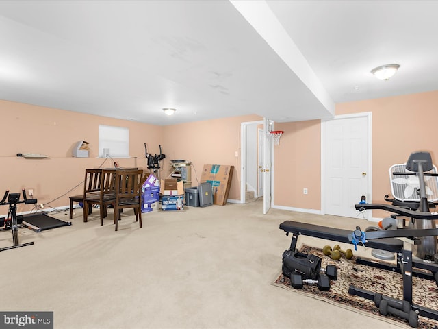 workout room featuring baseboards and carpet flooring