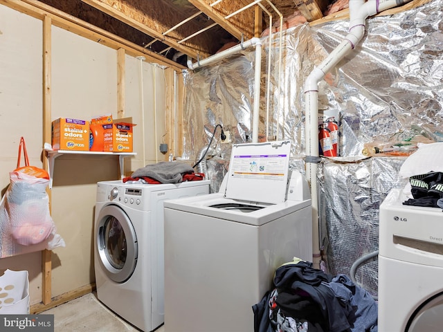 laundry area with separate washer and dryer and laundry area