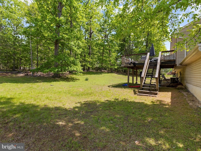 view of yard featuring stairway and a deck