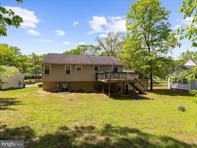 back of house featuring a lawn, a wooden deck, and stairway