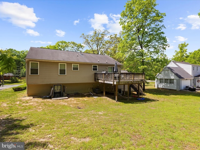 rear view of house featuring stairs, a yard, and a deck