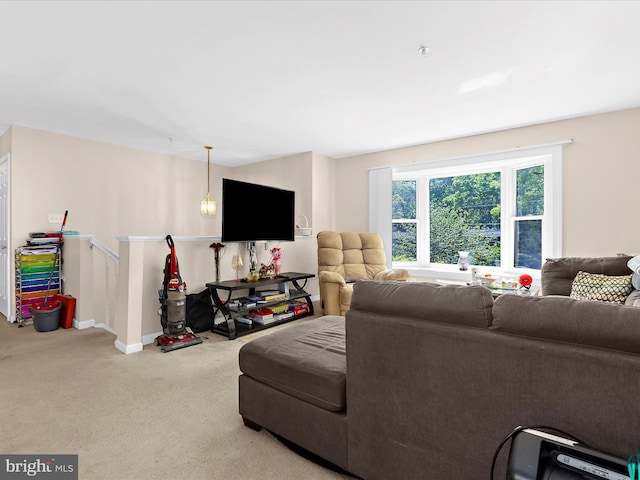 carpeted living room featuring baseboards